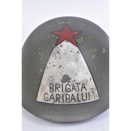 308 - A WWII Second World War Italian ' Brigata Garibaldi ' fascist helmet. The M33 helmet painted to the ... 