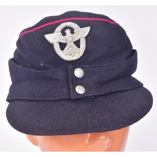 324 - A WWII Second World War Third Reich Nazi German Fireman's service cap. Blue with fuchsia piping and ... 