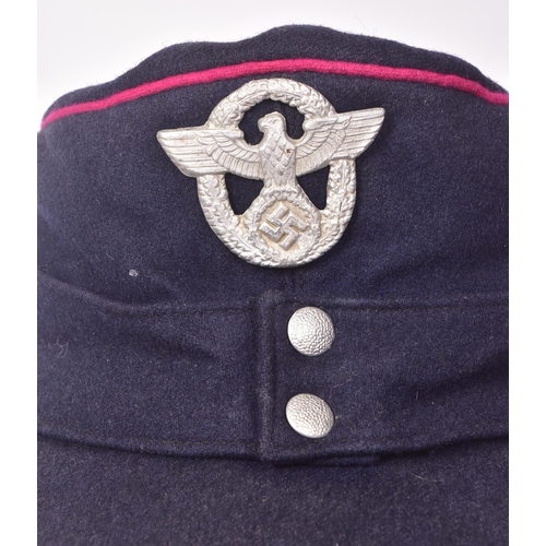 324 - A WWII Second World War Third Reich Nazi German Fireman's service cap. Blue with fuchsia piping and ... 