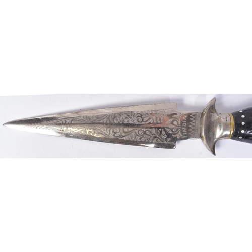 333 - A vintage Indian made dagger with a leather leg holster. The dagger with a round white metal pommel,... 