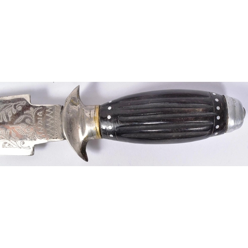 333 - A vintage Indian made dagger with a leather leg holster. The dagger with a round white metal pommel,... 