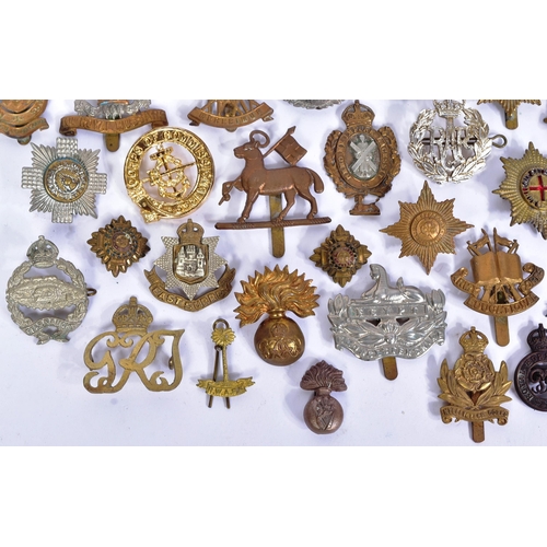 356 - A large collection of assorted British War time and post war military cap badges to include; Duke of... 