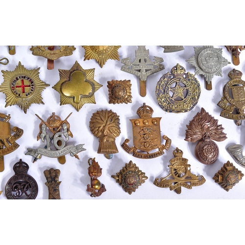 356 - A large collection of assorted British War time and post war military cap badges to include; Duke of... 