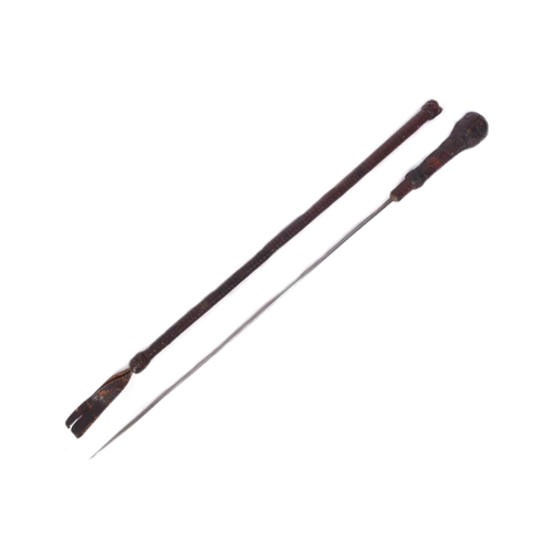 39 - A 19th Century Eastern riding crop with concealed blade. Dark tan leather plaited over the pommel an... 