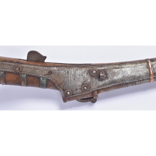 57 - A 19th Century South Asian / Indian Toradar / Matchlock rifle. Long barrel secured to the stock with... 
