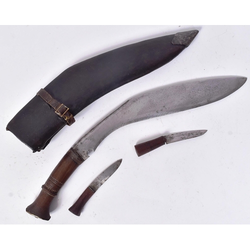 67 - An early 20th Century Nepalese / Gurkha Regiment Kukri knife dagger. The knife having a flat pommel ... 