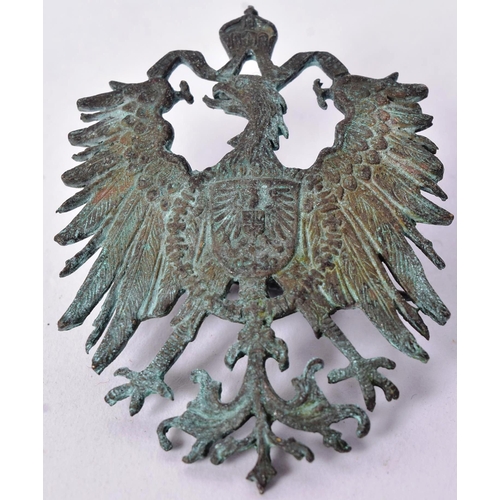 91 - A WWI First World War Imperial German Colonial hat badge depicting the Prussian heraldic eagle toppe... 