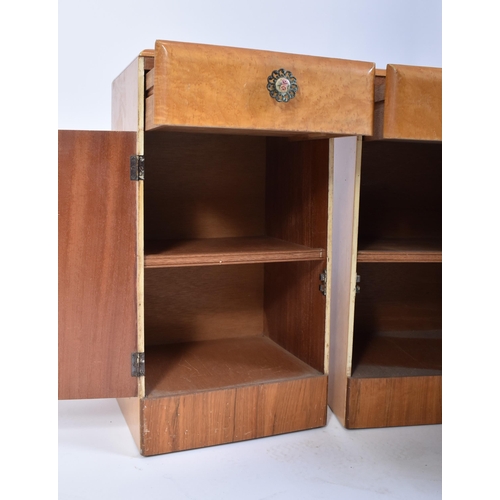 119 - A pair of post war Art Deco satin birch wood bedside cabinets. Each being raised on inset plinth bas... 