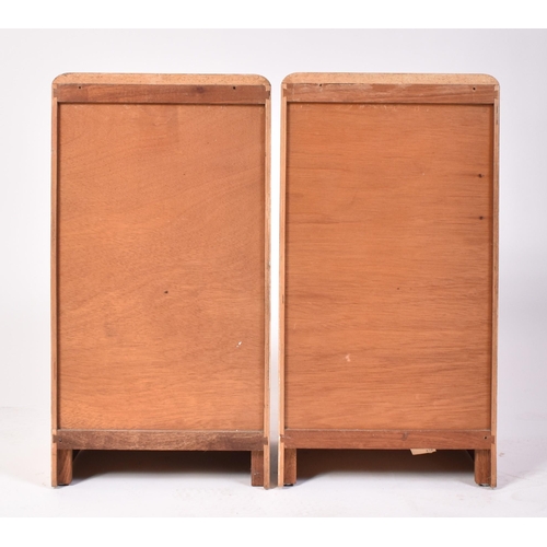 119 - A pair of post war Art Deco satin birch wood bedside cabinets. Each being raised on inset plinth bas... 