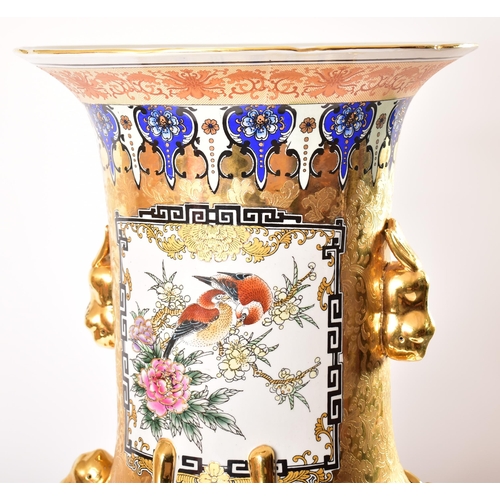 128 - A large 21st century Chinese style gilt & enamelled metal floor vase. The vase having a flared rim o... 