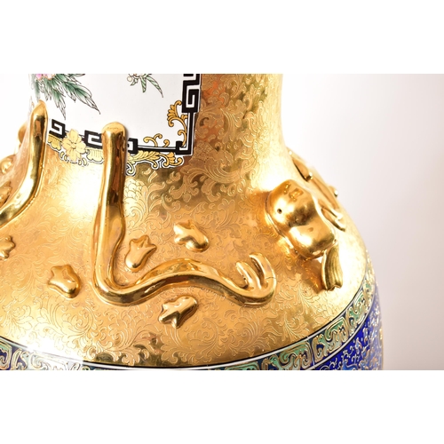 128 - A large 21st century Chinese style gilt & enamelled metal floor vase. The vase having a flared rim o... 