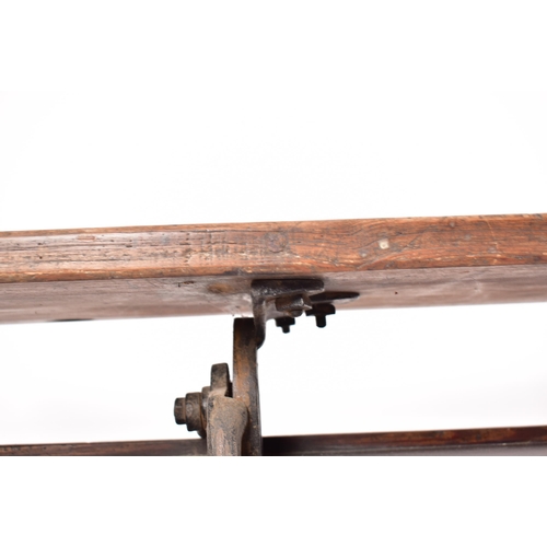 141 - An early 20th century solid pine & cast iron ecclesiastic church bench pew. The bench having a recta... 