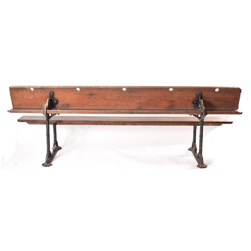 141 - An early 20th century solid pine & cast iron ecclesiastic church bench pew. The bench having a recta... 