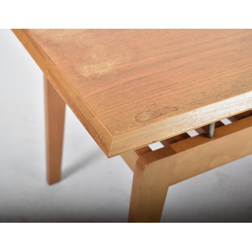 146 - A retro 20th century teak floating topped coffee / low table. The table having a beveled edge rectan... 