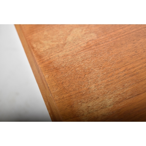 146 - A retro 20th century teak floating topped coffee / low table. The table having a beveled edge rectan... 