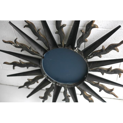 149 - A large vintage 20th century metal worked wall hanging sunburst mirror. Central circular mirror plat... 