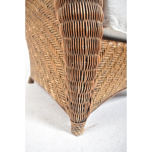 158 - A 20th century rattan and wicker framed conservatory armchair. The chair with deep scrolled back and... 