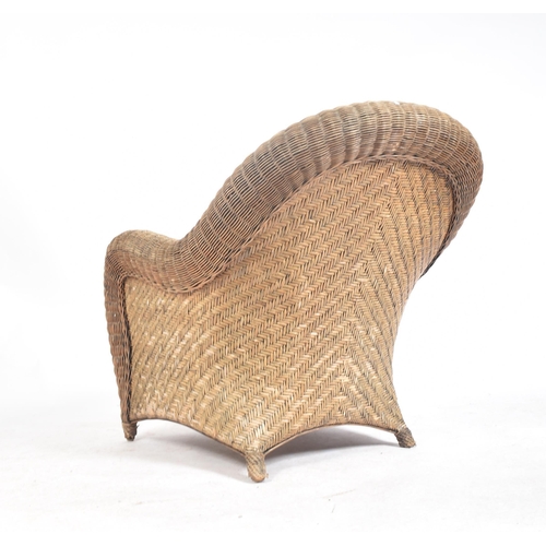 158 - A 20th century rattan and wicker framed conservatory armchair. The chair with deep scrolled back and... 