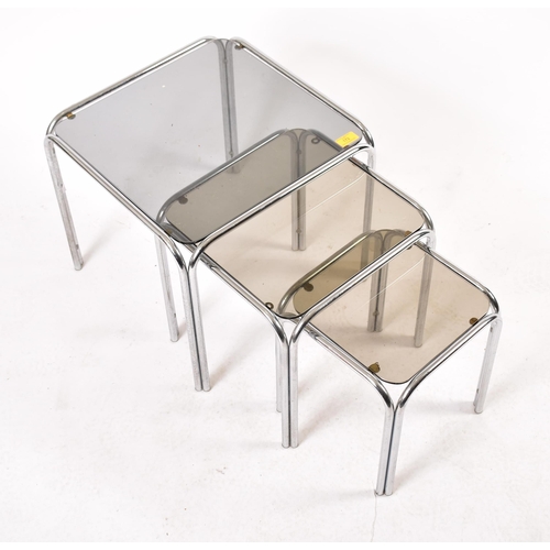 172 - A retro 20th century 1970s chrome and smoked glass nest of tables. Each nesting table having chrome ... 