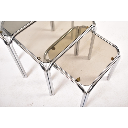 172 - A retro 20th century 1970s chrome and smoked glass nest of tables. Each nesting table having chrome ... 