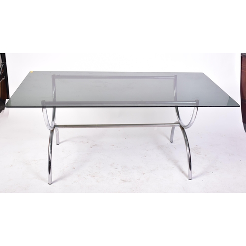 203 - A retro 20th century 1970s designer chrome and and smoked glass dining table and matching four chair... 