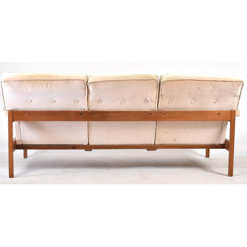 224 - Guy Rogers - A retro 20th century British design teak framed three seater sofa settee. The sofa with... 