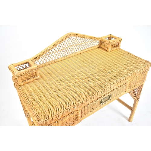 227 - A vintage 20th century wicker rattan writing office desk in the manner of Henry Link. The desk havin... 