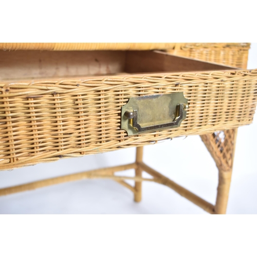 227 - A vintage 20th century wicker rattan writing office desk in the manner of Henry Link. The desk havin... 