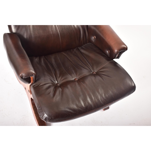 237 - A retro 20th century Danish teak and leather armchair. Tall padded backrest cushioned seat rest with... 