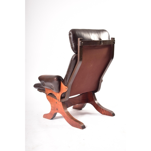 237 - A retro 20th century Danish teak and leather armchair. Tall padded backrest cushioned seat rest with... 