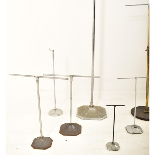 242 - A collection of early 20th century milliner's display stands, used for hats, wigs & scarves. Fourtee... 