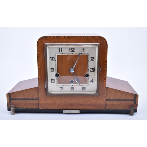 243 - An Art Deco style mid century walnut Westminster chime mantlepiece clock. The mantle clock of walnut... 