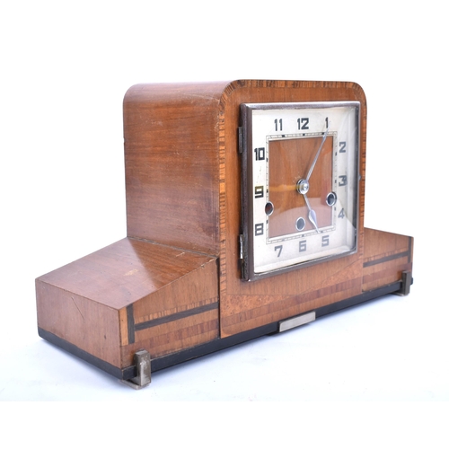 243 - An Art Deco style mid century walnut Westminster chime mantlepiece clock. The mantle clock of walnut... 