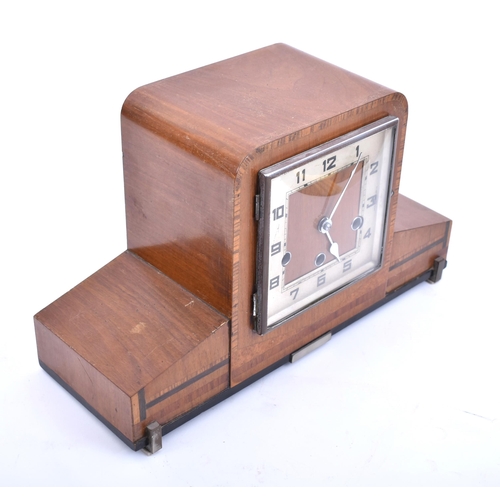 243 - An Art Deco style mid century walnut Westminster chime mantlepiece clock. The mantle clock of walnut... 