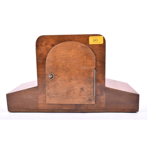 243 - An Art Deco style mid century walnut Westminster chime mantlepiece clock. The mantle clock of walnut... 