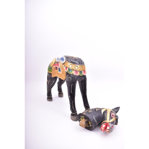 257 - A mid 20th century hand painted Indian style wooden toy horse. The horse black, with gilt highlights... 