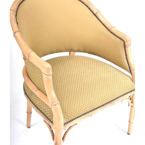 288 - A vintage 20th century faux bamboo tub armchair. The chair having a curved backrest with faux bamboo... 