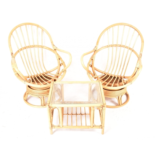 298 - A pair of retro 20th century bamboo and wicker / cane swivel armchair / egg chairs. Each chair havin... 