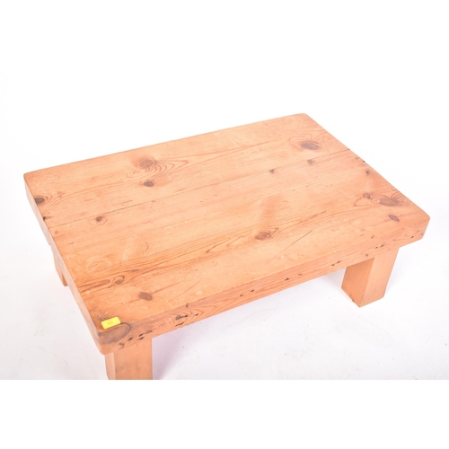 302 - A vintage 20th century railway sleeper pine coffee table / low table. The table having a pine top co... 