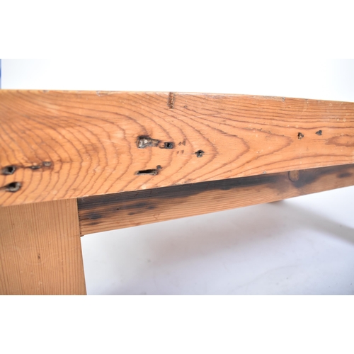 302 - A vintage 20th century railway sleeper pine coffee table / low table. The table having a pine top co... 