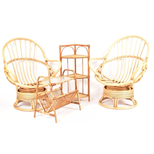 313 - A pair of retro 20th century bamboo and wicker / cane swivel armchair / egg chairs. Each chair havin... 