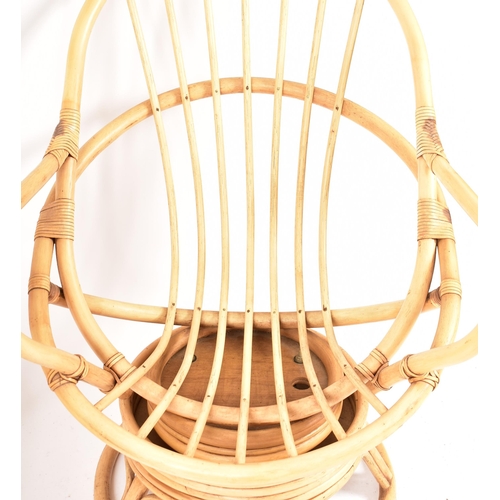 313 - A pair of retro 20th century bamboo and wicker / cane swivel armchair / egg chairs. Each chair havin... 