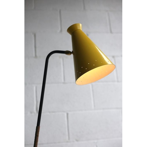 325 - A retro mid century 1950s atomic floor standing lamp light. The lamp having a yellow pendant perfora... 