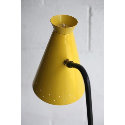 325 - A retro mid century 1950s atomic floor standing lamp light. The lamp having a yellow pendant perfora... 