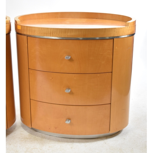 352 - A pair of vintage 20th century satin birch oval shaped bedside chests / tables. Each chest having a ... 