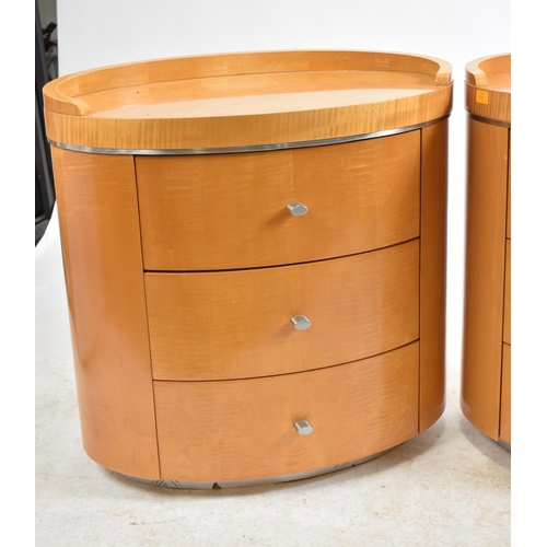 352 - A pair of vintage 20th century satin birch oval shaped bedside chests / tables. Each chest having a ... 