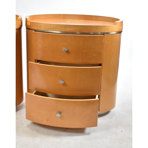 352 - A pair of vintage 20th century satin birch oval shaped bedside chests / tables. Each chest having a ... 