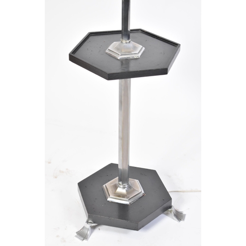 36 - A 20th century Art Deco chrome and ebony lamp standard. The light having a single chrome stem with c... 