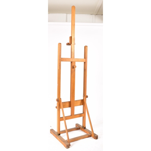 366 - A vintage 20th century oak artist easel. The easel being adjustable raised on trestle supports unite... 