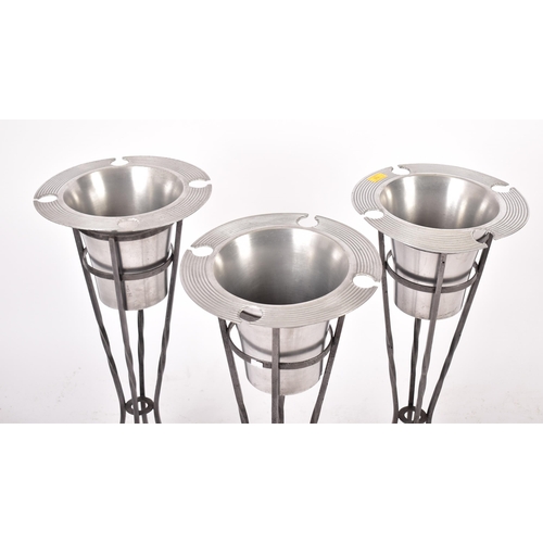 374 - Three vintage late 20th century chrome stainless steel champagne ice buckets, each in a twisted cast... 